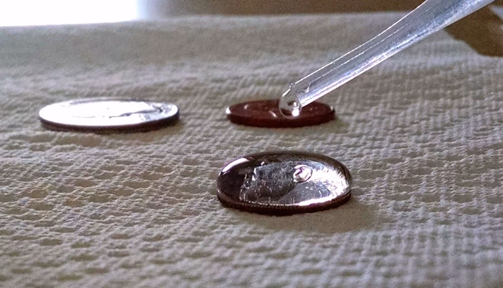 Why can we put 50 drops of water onto a penny without it spilling?