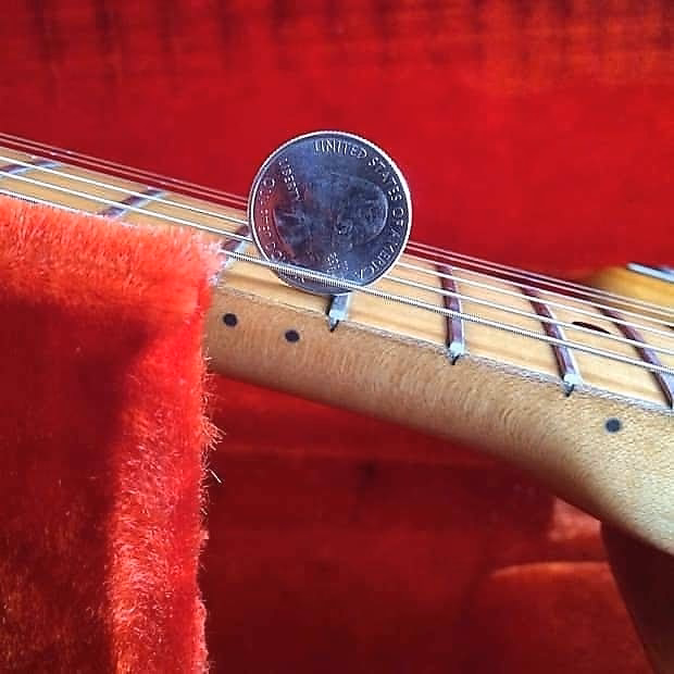 What guitarist uses coins as picks?